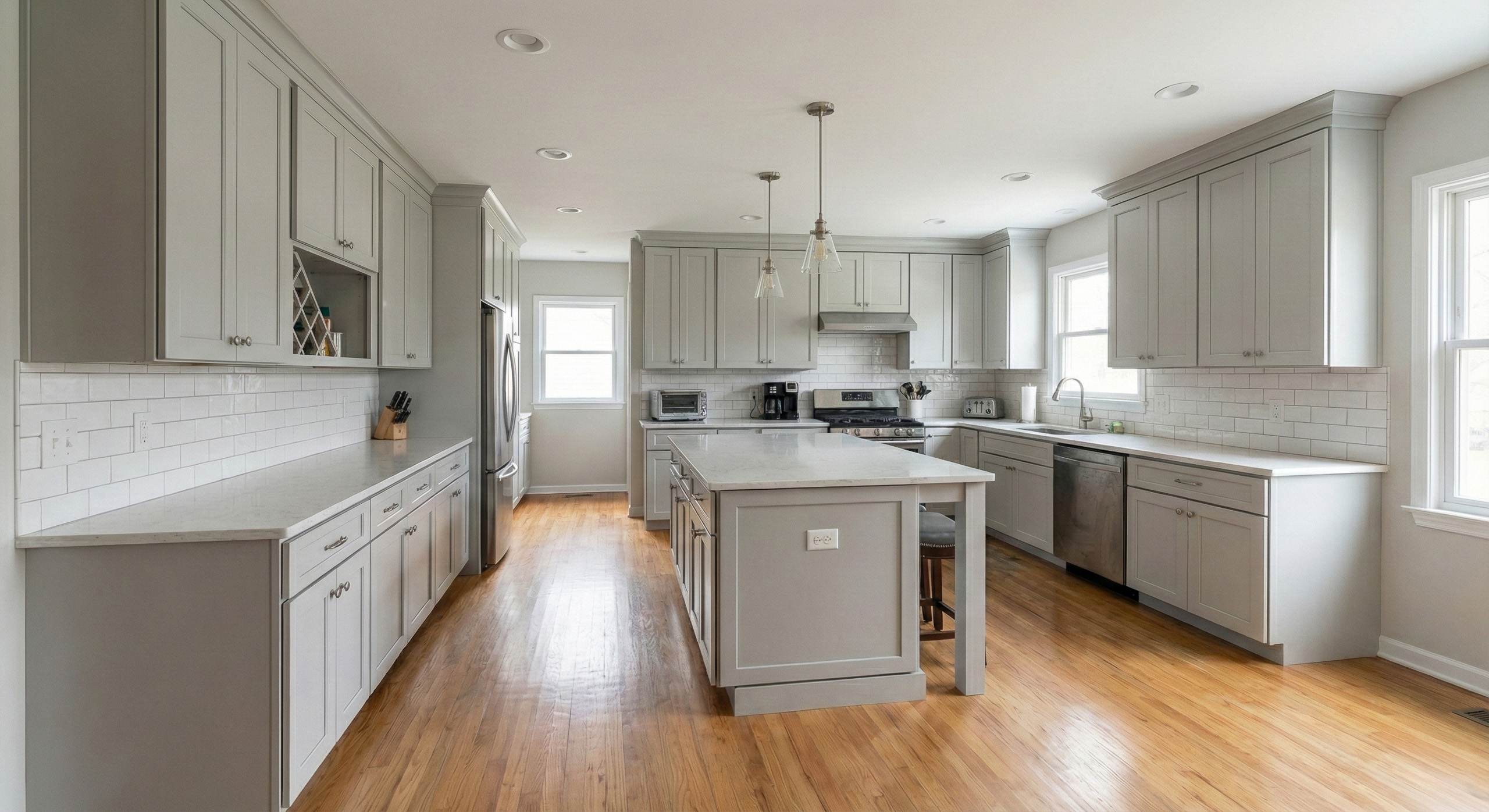 Renovated residential kitchen with updated cabinetry, island, and natural light